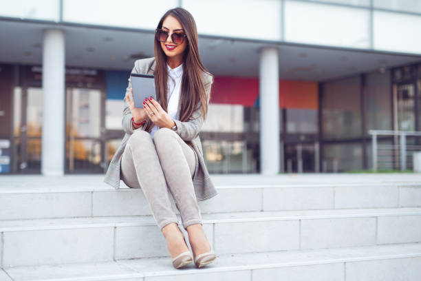 istock Businesswoman using digital tablet on the street 1193066656