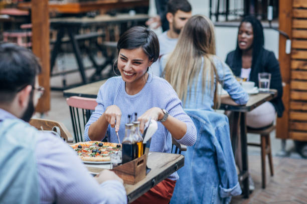 istock Man and woman sitting outdoors in restaurant 1193066891