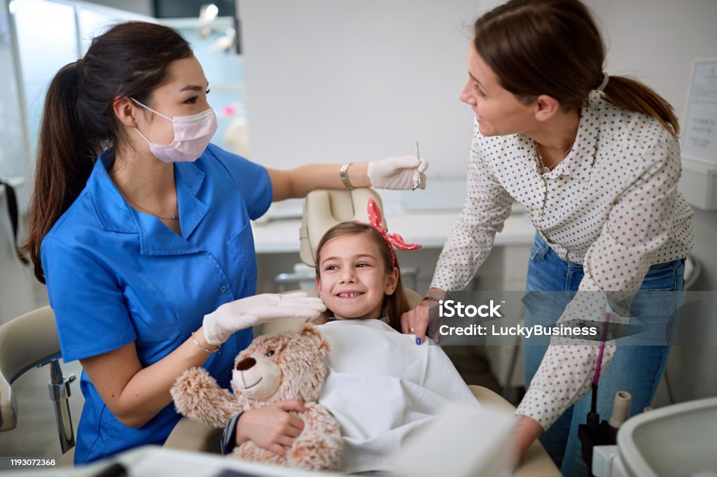 Dentist woman examining tooth patient in ambulant. Dentist woman examining tooth young patient in ambulant. Adult Stock Photo
