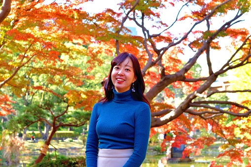A 24 year old Japanese woman is appreciating beautiful autumn foliage, consisting of Japanese maple and ginkgo trees, in Hibiya Park, Tokyo.
Hibiya Park is Japan's first Western-style public park in the center of Tokyo, bordering the southern moat of the Imperial Palace. The autumn foliage, consisting of Japanese maple, ginkgo tree and other trees, is especially beautiful. The park is open to the public for 24 hours a day, free of charge.