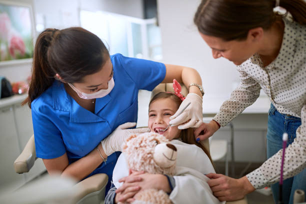 little girl visiting dentist .dentist examining tooth patient in ambulant. - ambulant patient imagens e fotografias de stock