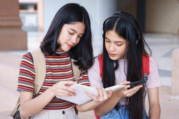istock Asian university students chatting, talking in university campus. 1193072508