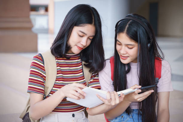 istock Asian university students chatting, talking in university campus. 1193072581