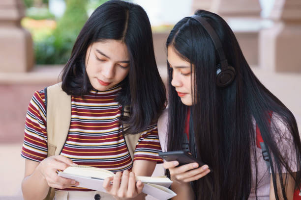 istock Asian university students chatting, talking in university campus. 1193072658
