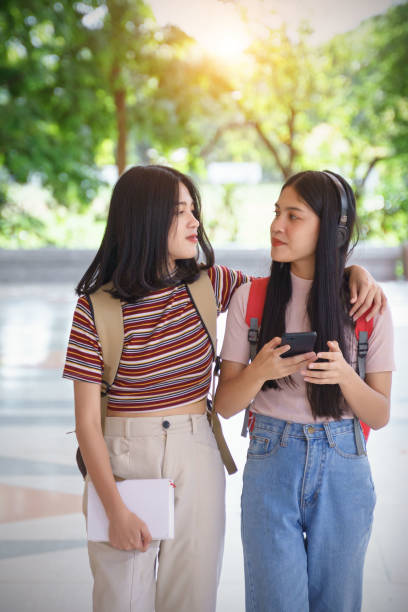 istock Asian university students chatting, talking in university campus. 1193072713