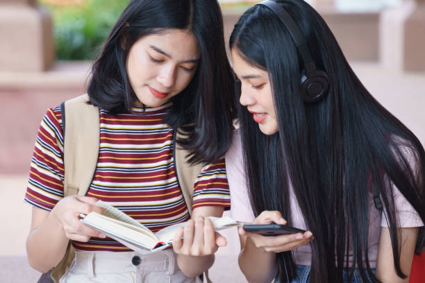 istock Asian university students chatting, talking in university campus. 1193072793