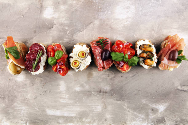 istock Appetizers table with italian antipasti snacks and wine in glasses. Brushetta or authentic traditional spanish tapas set, cheese variety 1193073786