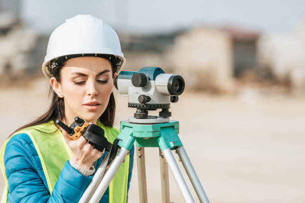istock Surveyor with digital level talking on radio set 1193074057