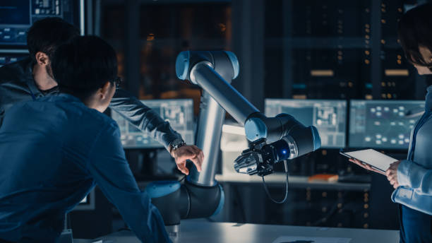 istock Close Up Vertical Shot of Artificial Intelligence Operating a Futuristic Robotic Arm in a Game of Chess. Robot Moves a Knight. High Tech Modern Research Laboratory. 1193074071