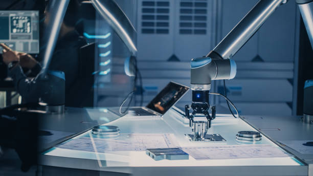istock Futuristic Artificial Intelligence Robotic Arm Operates and Moves a Metal Object, Picks It Up or Puts it Down. High Tech Research Laboratory with Modern Equipment. 1193074154