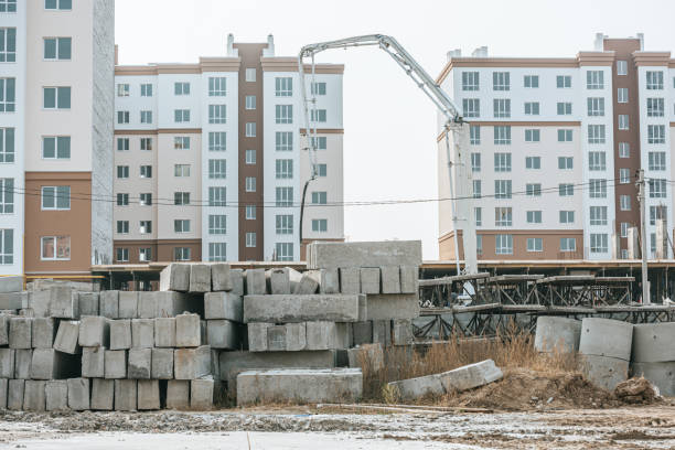 istock Construction site with concrete blocks and heavy machinery 1193074187