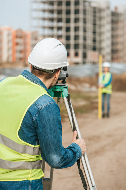 istock Selective focus of surveyors measuring land with digital level on construction site 1193074221