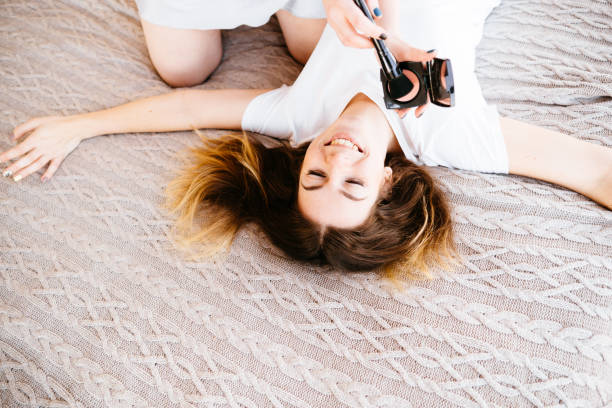 istock Friends laughing applying make up to each other 1193076576