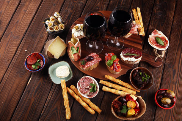 istock Appetizers table with italian antipasti snacks and wine in glasses. Brushetta or authentic traditional spanish tapas set, cheese variety 1193076597