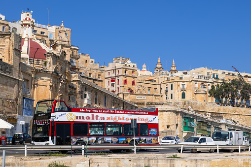 Valletta, Malta - October 11, 2019: Hop on hop off sightseeing bus on a tour in the capital city
