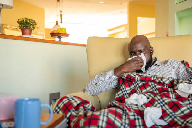 istock Sick Mature African is Suffering from Flu and Blowing his Nose 1193078345