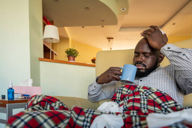 istock Sick Mature African is Suffering from Flu and Drinking a Hot Cup of Tea 1193078481