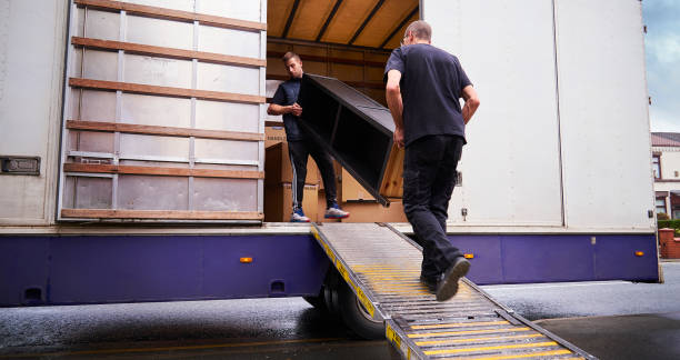 Loading removal truck Removal company helping a family move out of their old home moving van stock pictures, royalty-free photos & images