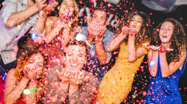 istock Young friends having party throwing confetti - Young people celebrating on weekend night - Entertainment, fun, new year's eve, nightlife, holidays, concept - Focus on close-up man hands 1193079466