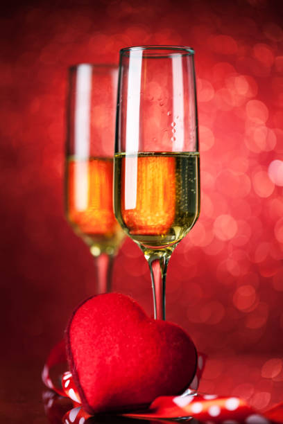 istock Champagne glasses on a beautiful bokeh background. Valentine's day. Background with copy space. Selective focus. Vertical. 1193079697