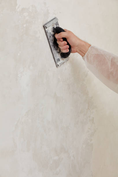 istock Hand of a man sanding a wall after plastering 1193079705