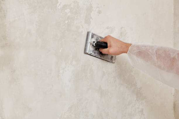 istock Hand of a man sanding a wall after plastering 1193079718