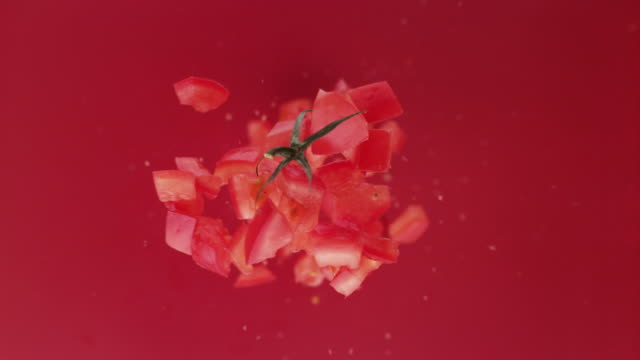 Chpped Tomato fruit. Studio beauty shot.