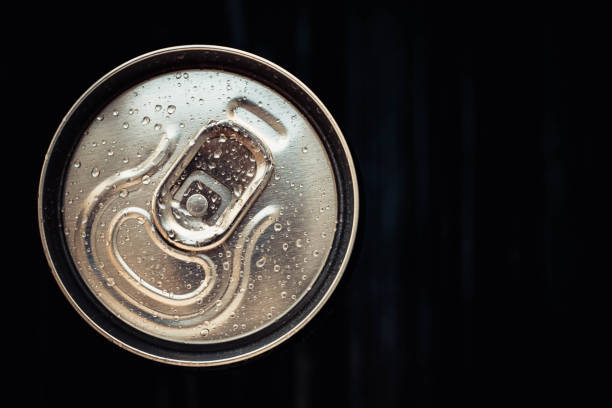 istock Closed can of cola on black background. Top view. Can drink with water drops. Copy, text space. 1193080170