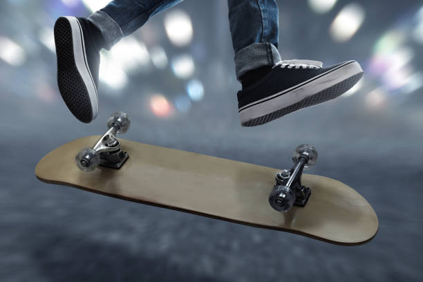 Young people. Skateboarder with blurred motion silhouetted in late afternoon sun.