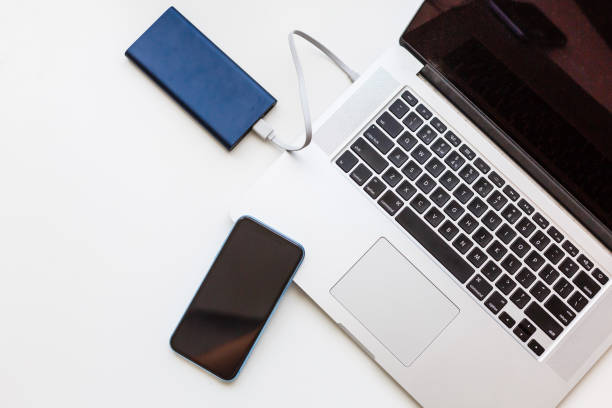 istock Charging of mobile phone and laptop computer new technology concept 1193081106
