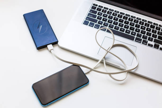 istock Charging of mobile phone and laptop computer new technology concept 1193081119