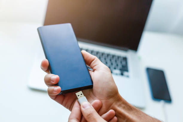 istock power bank in laptop hands 1193081399