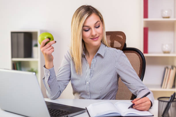 istock Businesswoman eating apple 1193083062