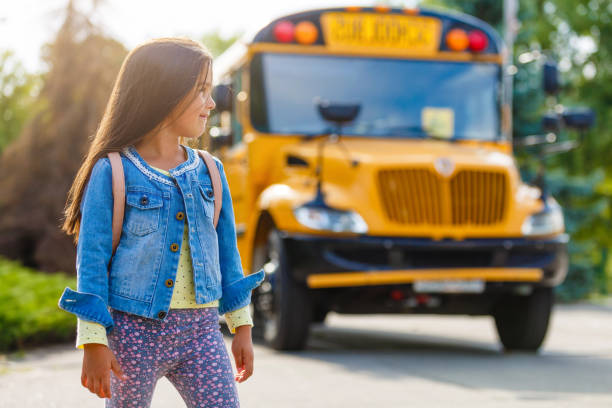 istock schoolgirl is waiting for a school bus 1193088612