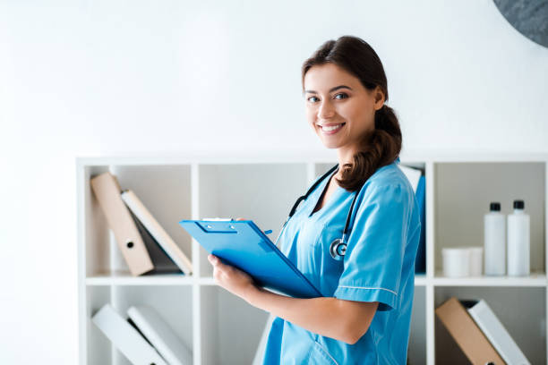 istock beautiful veterinarian smiling at camera while writing prescription on clipboard 1193092128