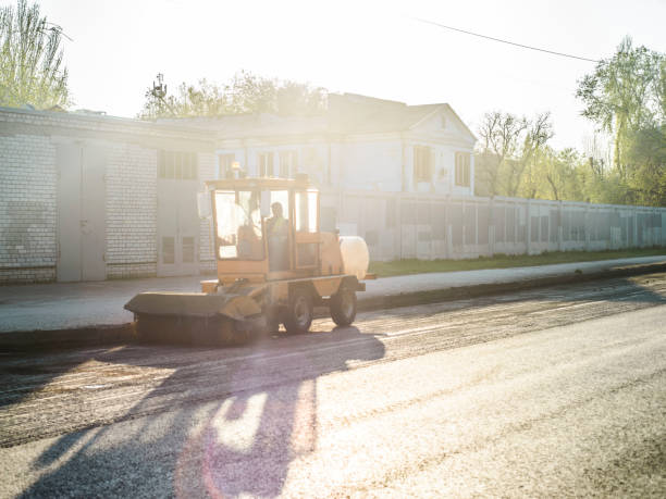 istock road repair work. A team of working engineers, laying asphalt 1193092240