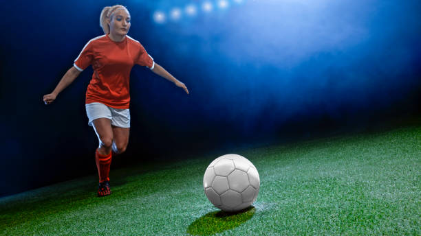 istock Young woman playing football 1193092337