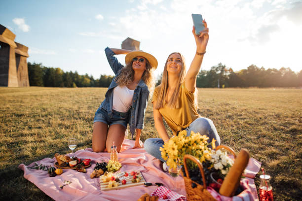 istock Beautiful young women doing selfies on a picnic 1193092455