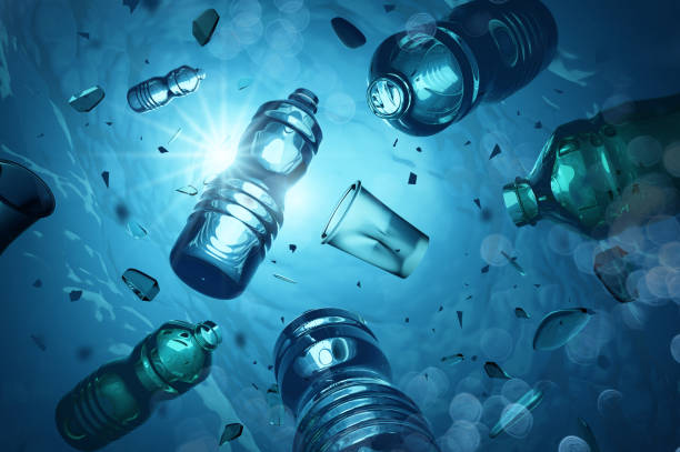 Plastic Ocean Pollution And Microplastics Problem plastic bottles and microplastics floating in the open ocean. Marine plastic pollution concept. 3D illustration bottle stock pictures, royalty-free photos & images