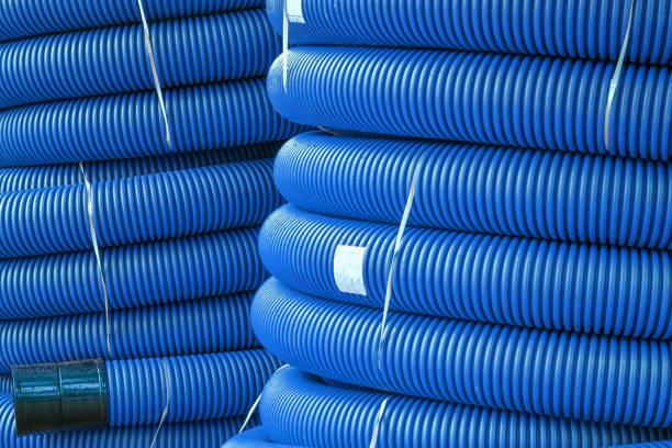 istock Coils of new red plastic pipe for underground cable protection with rain drops 1193096856