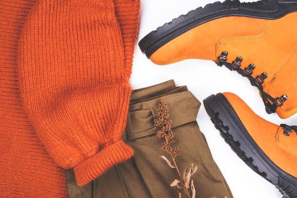 istock Warm clothes and boots on the table. 1193096939