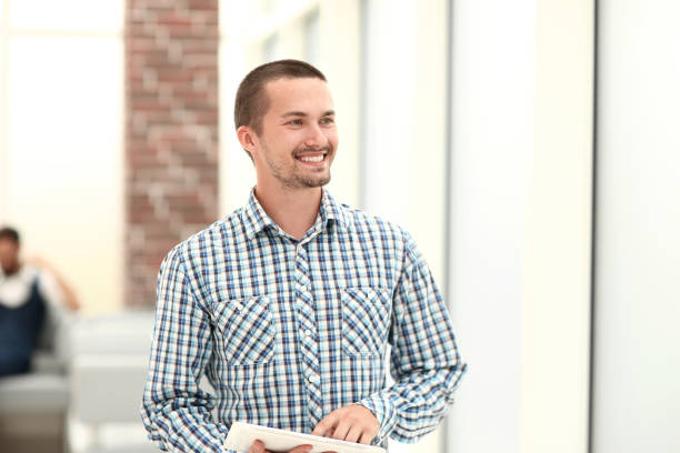 istock modern man standing near the office window . 1193097088