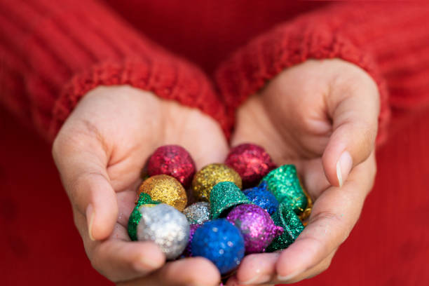 istock Hands Holding Decorative Christmas Balls Background 1193099359