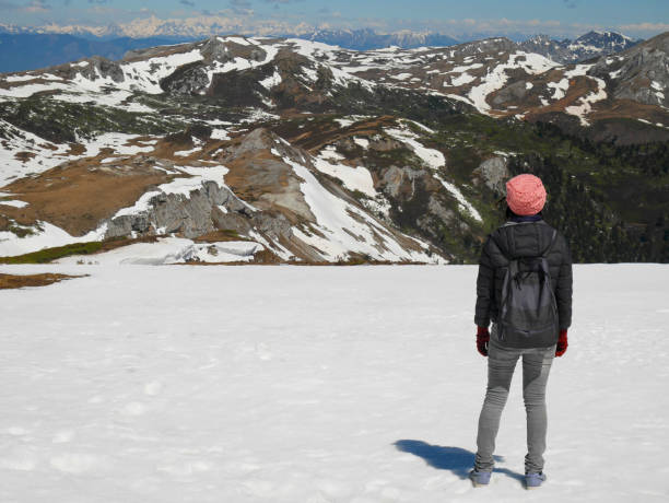 istock Woman standing on snow mountain 1193099417