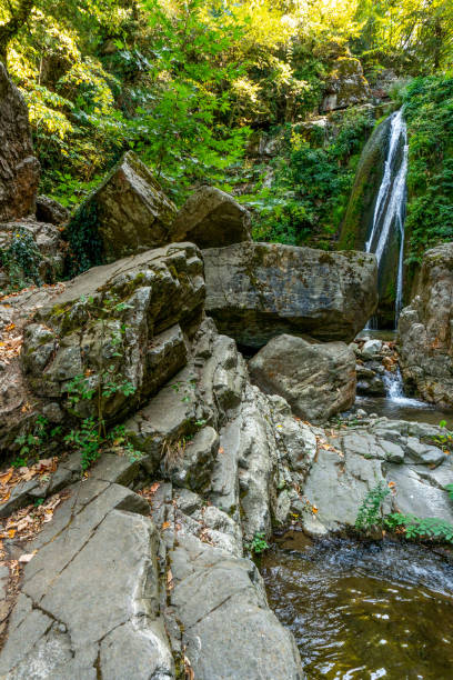istock Waterfall and rocks on the background of trees in Greece 1193099610
