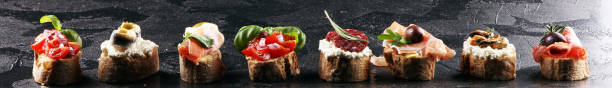 istock Appetizers table with italian antipasti snacks and wine in glasses. Brushetta or authentic traditional spanish tapas set, cheese variety 1193100622