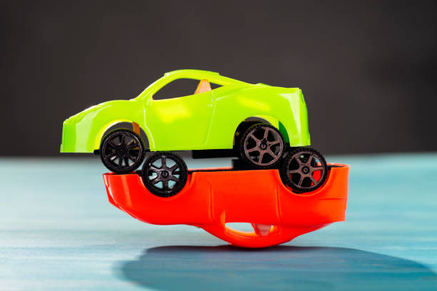 istock A green is standing on a red car 1193100863