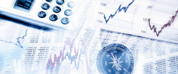 istock Stock market prices with compass and calculator 1193100881