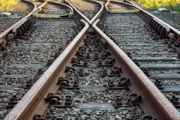 Railroad track with switch and wooden ties Railroad track with a switch to change lane in full perspective focus parallel photos stock pictures, royalty-free photos & images