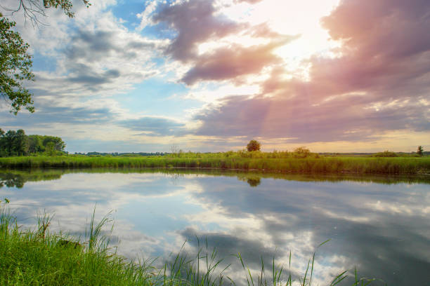 istock The blue sky with the clouds above the clear blue lake 1193104155